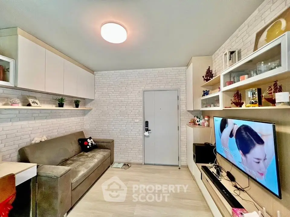 Modern living room with stylish decor and wall-mounted TV, perfect for relaxation.