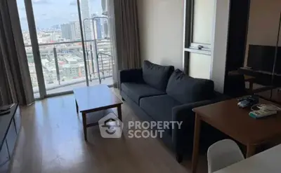 Modern living room with city view and stylish furniture in high-rise apartment.