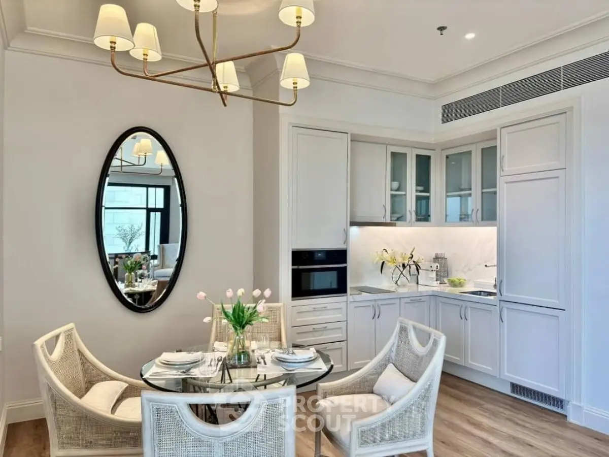 Elegant kitchen with dining area featuring modern chandelier and stylish decor
