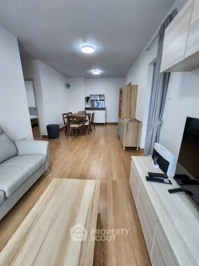 Spacious modern living room with wooden flooring and stylish furniture