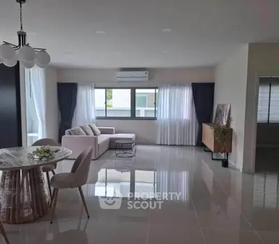 Spacious modern living room with elegant decor and large windows