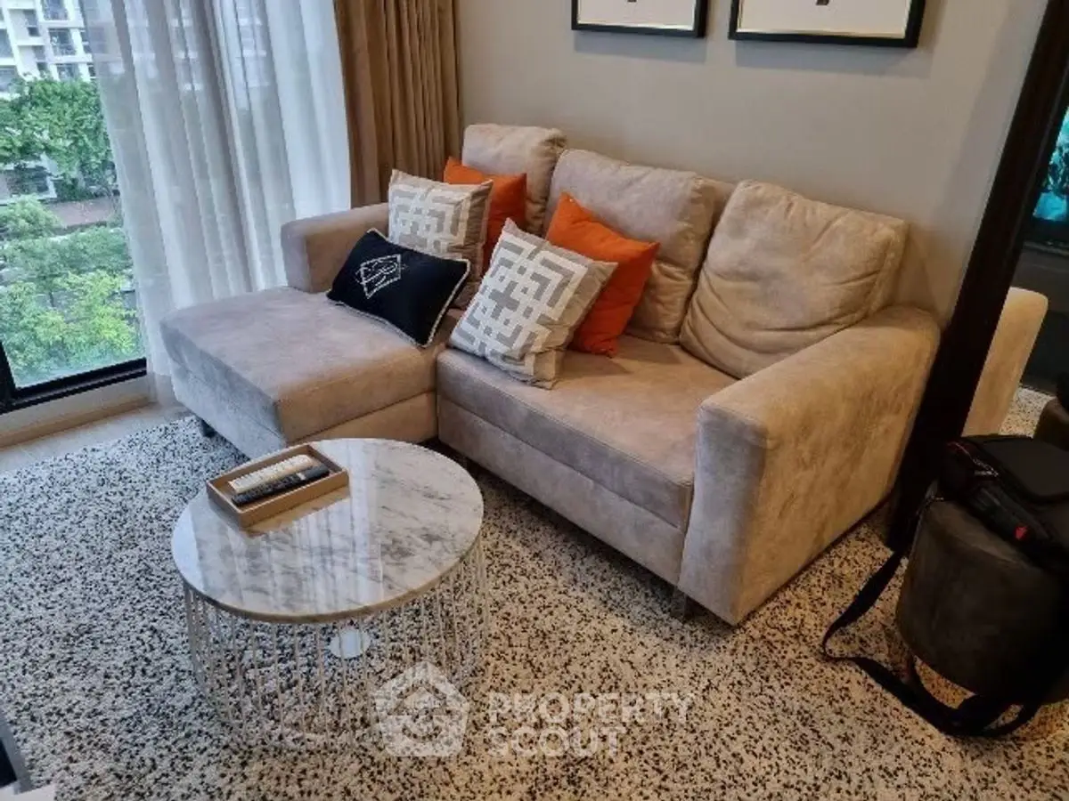 Cozy living room with plush sofa and stylish coffee table, perfect for relaxation.