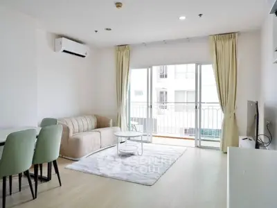 Bright modern living room with balcony access and stylish furniture