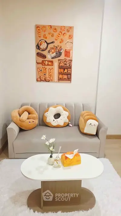 Charming living room with cozy sofa and playful bread-themed decor, perfect for relaxation and entertaining.