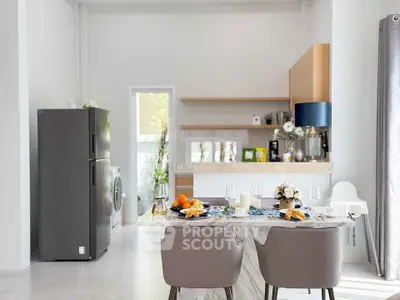 Modern dining area with elegant table setting and sleek kitchen appliances
