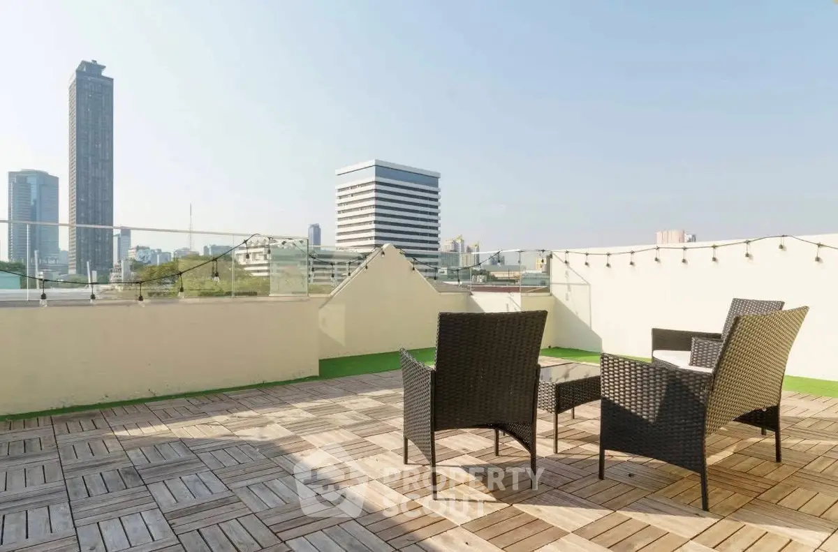 Spacious rooftop terrace with city skyline views and stylish outdoor seating.