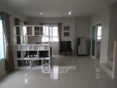 Spacious open-plan living area with modern decor and ample natural light.