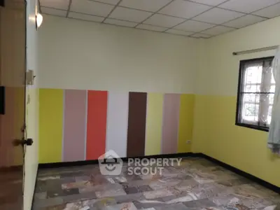 Vibrant room with colorful accent wall and tiled flooring, perfect for creative living space.