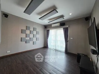 Spacious modern living room with sleek design and large window for natural light.