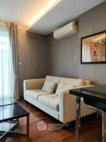 Modern living room with cozy sofa and air conditioning in stylish apartment.