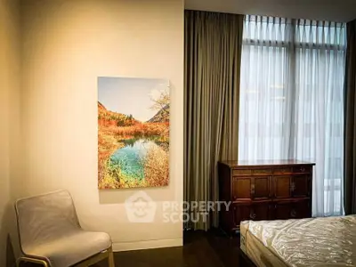 Elegant bedroom with large window, stylish furniture, and scenic wall art.