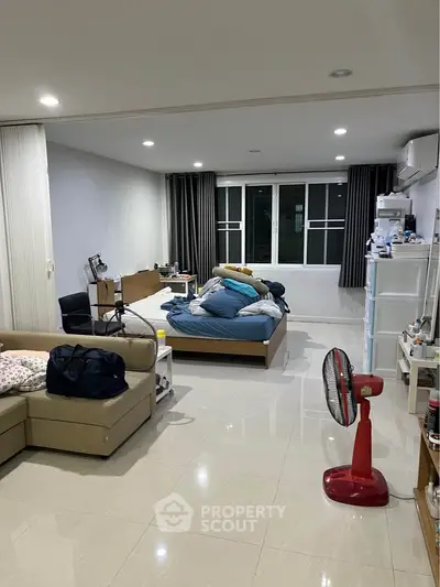 Spacious bedroom with modern furnishings and ample natural light.