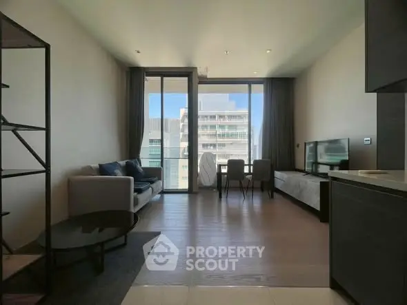 Modern living room with large windows and city view, stylish furniture, and open layout.