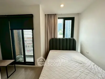 Modern bedroom with large window and city view, featuring a cozy bed and minimalist decor.