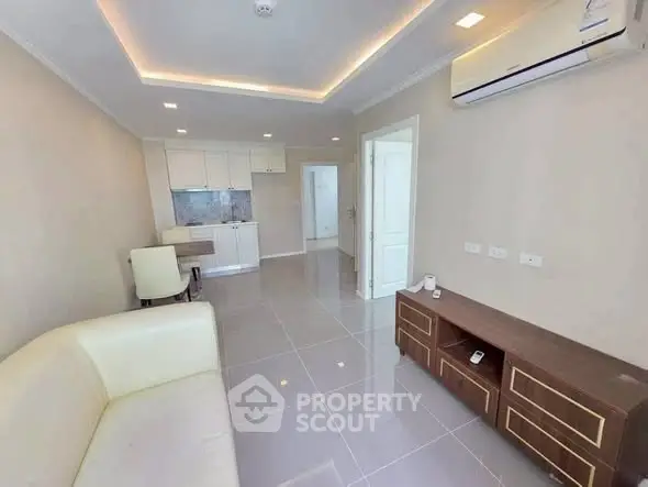 Modern living room with sleek design and open kitchen layout