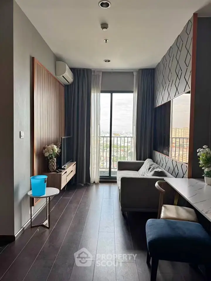 Modern living room with stylish decor and city view from balcony.