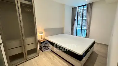 Modern bedroom with large window and stylish furnishings