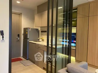 Modern compact kitchen with sleek cabinetry and integrated appliances in stylish apartment.