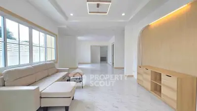 Spacious modern living room with elegant furniture and large windows for natural light.
