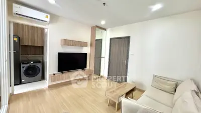 Modern living room with sleek design, featuring a wall-mounted TV, cozy sofa, and integrated laundry area.