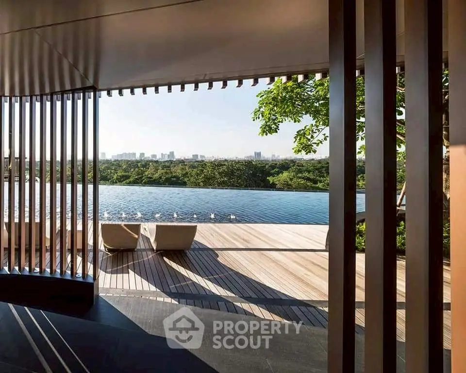 Luxurious rooftop pool with stunning city skyline view and elegant wooden deck.