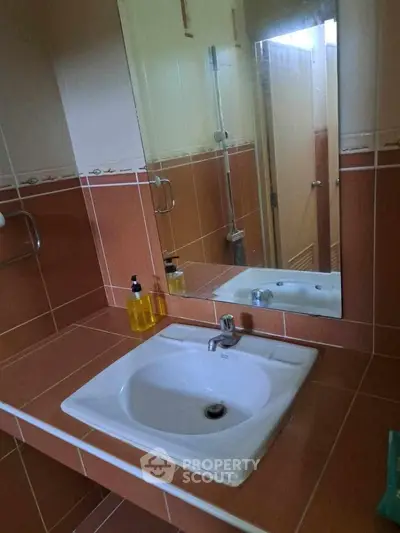 Modern bathroom with stylish sink and mirror in a cozy setting