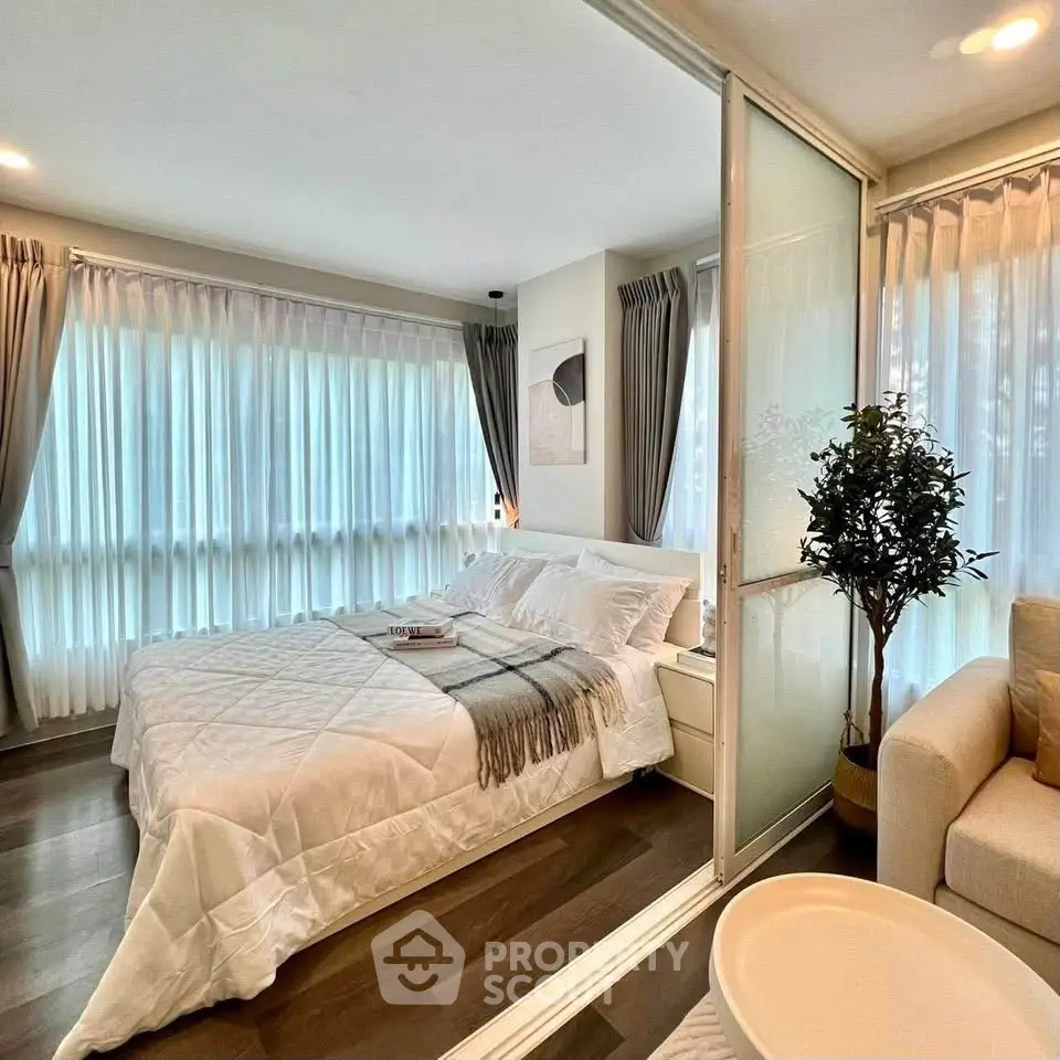 Luxurious bedroom with elegant decor and large windows for natural light