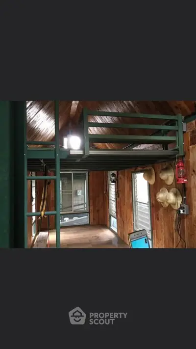Rustic wooden interior with loft bed and natural light