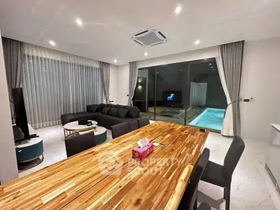 Luxurious living room with pool view and modern furnishings