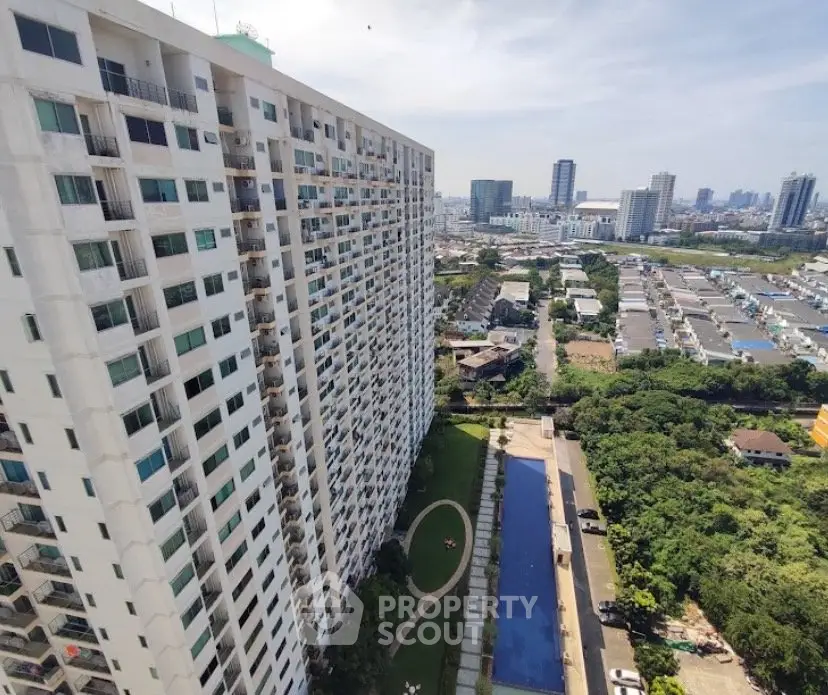 High-rise residential building with pool and cityscape view