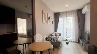 Modern living room with cozy seating and natural light in stylish apartment.