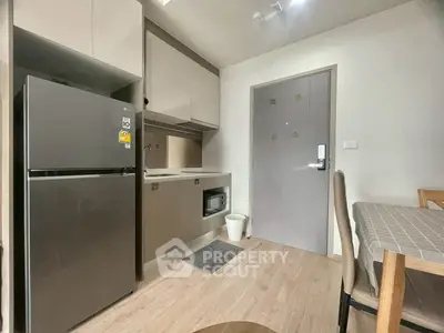 Modern kitchen with sleek appliances and dining area in a stylish apartment