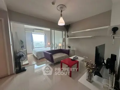 Modern studio apartment with open layout and city view, featuring sleek furniture and bright lighting.
