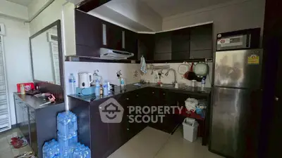 Modern kitchen with dark cabinets and stainless steel appliances