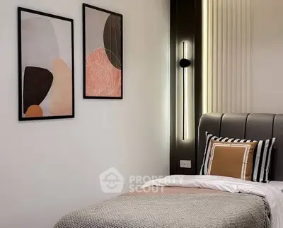 Stylish modern bedroom with abstract art and cozy bedding
