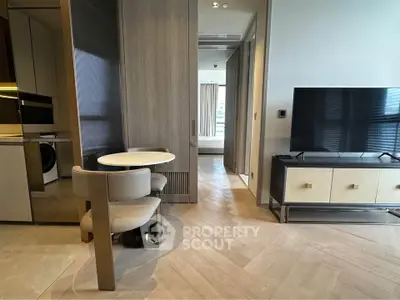 Modern apartment interior with stylish furniture and sleek TV setup, showcasing a cozy dining area and bedroom view.