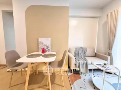 Modern living room with stylish dining area and cozy seating, featuring neutral tones and contemporary decor.