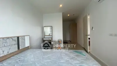 Spacious bedroom with modern decor and natural light