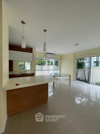 Spacious modern kitchen with open layout and large windows