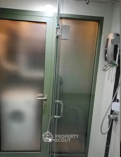 Modern bathroom with glass shower door and sleek fixtures