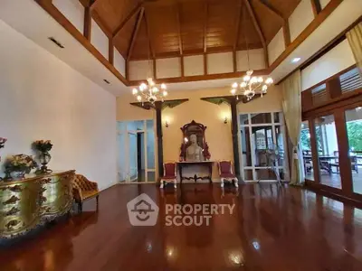 Elegant living room with high wooden ceiling and classic decor