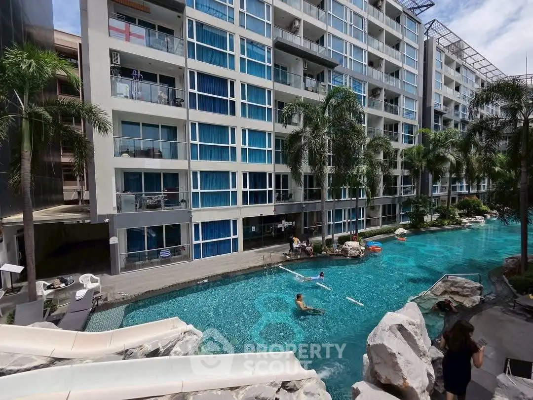 Luxurious apartment complex with stunning pool and modern architecture.