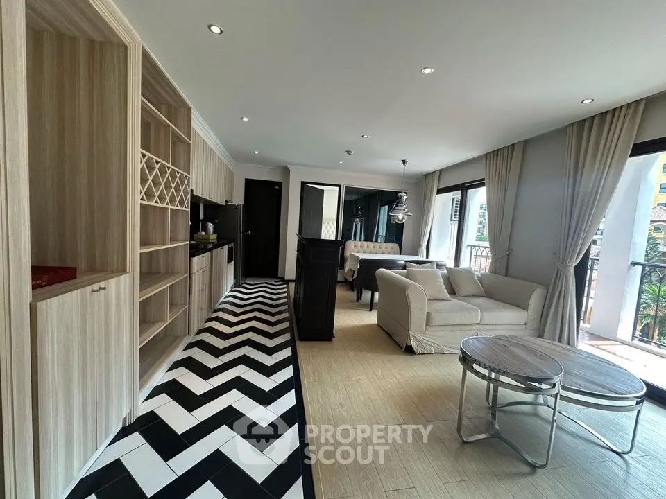Spacious modern living room with open kitchen and stylish flooring in a bright apartment