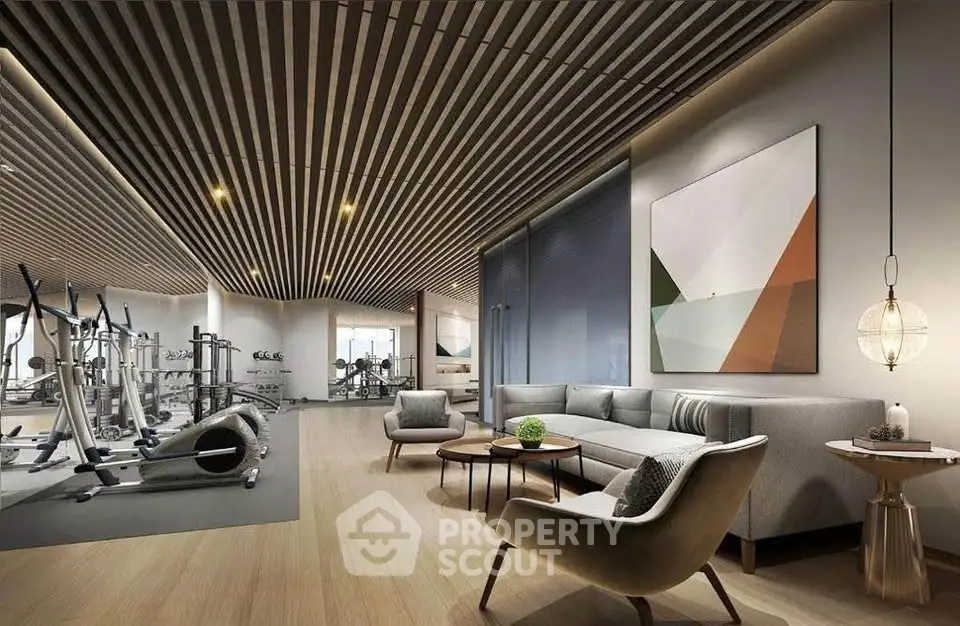Luxurious gym with modern equipment and stylish lounge area in upscale residential building.