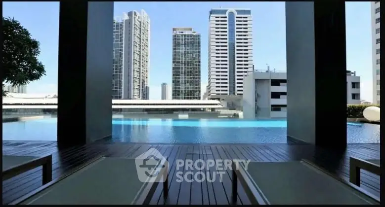 Luxurious urban poolside view with modern skyscrapers in the background, perfect for relaxation.