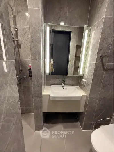 Modern bathroom with sleek design and elegant fixtures in a contemporary apartment.
