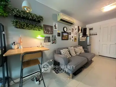 Charming living room with cozy sofa, stylish decor, and modern lighting in a contemporary apartment.