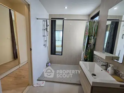 Modern bathroom with sleek design and large mirror in contemporary home