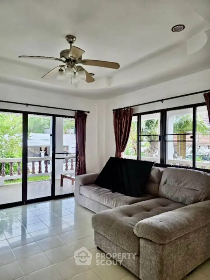 Spacious living room with large windows and cozy sectional sofa