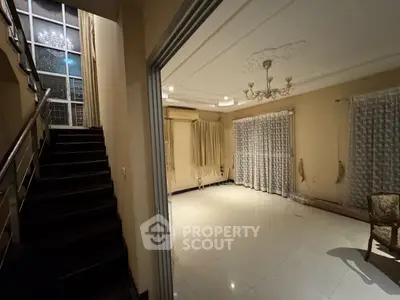 Spacious living room with elegant chandelier and large windows